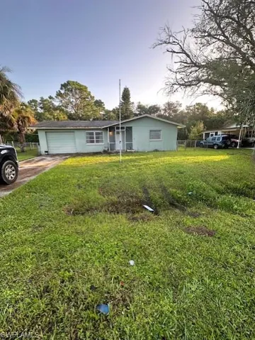 Ranch-style house with concrete driveway and a garage