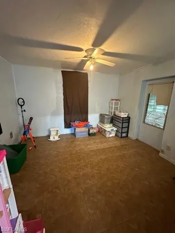 Family room featuring ceiling fan and a textured ceiling