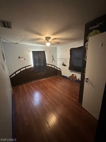 Bedroom featuring wood-type flooring and a ceiling fan