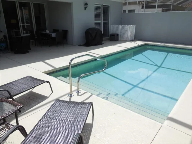 View of swimming pool featuring a grill, a fenced in pool, fence, and a patio