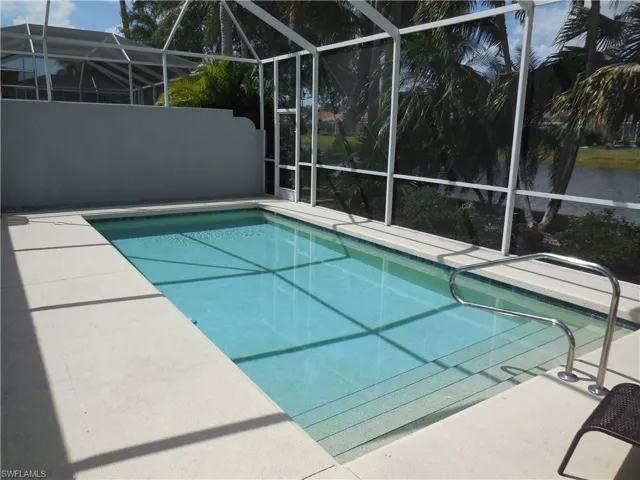 Outdoor pool with a lanai and a patio area