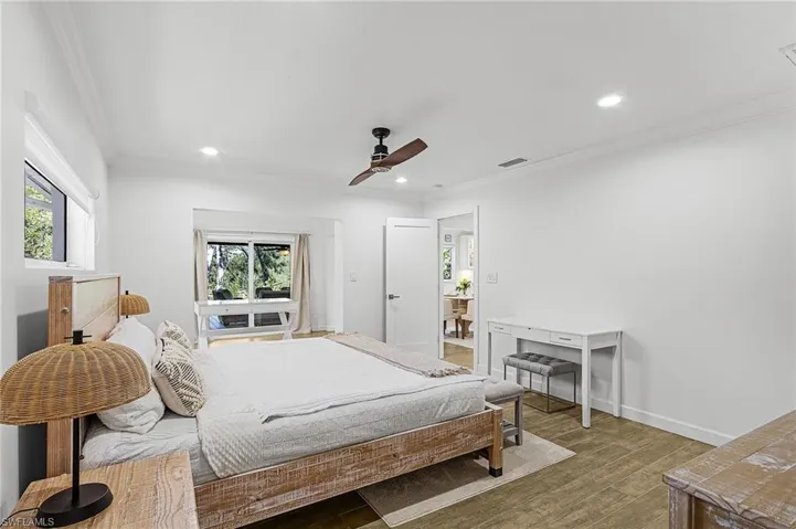 Bedroom featuring ornamental molding, wood finished floors, ceiling fan, and recessed lighting