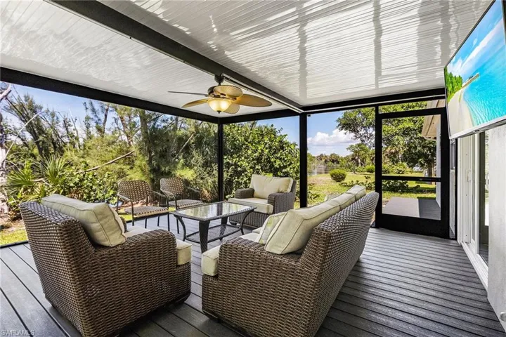 Sunroom with an outdoor hangout area, a ceiling fan, and a wooden deck