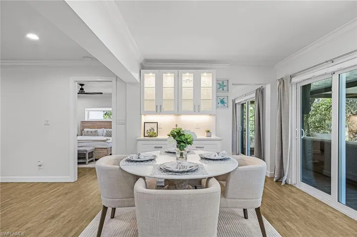 Dining space with crown molding, light wood-style floors, ceiling fan, and recessed lighting