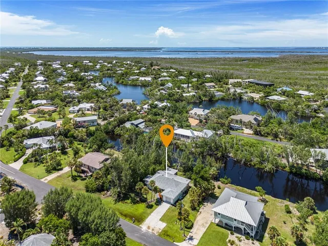Aerial view of residential area featuring a nearby body of water