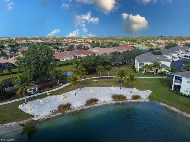 Aerial perspective of suburban area featuring a nearby body of water