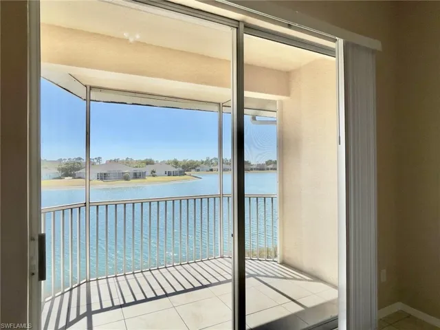 Balcony featuring a water view and a sunroom