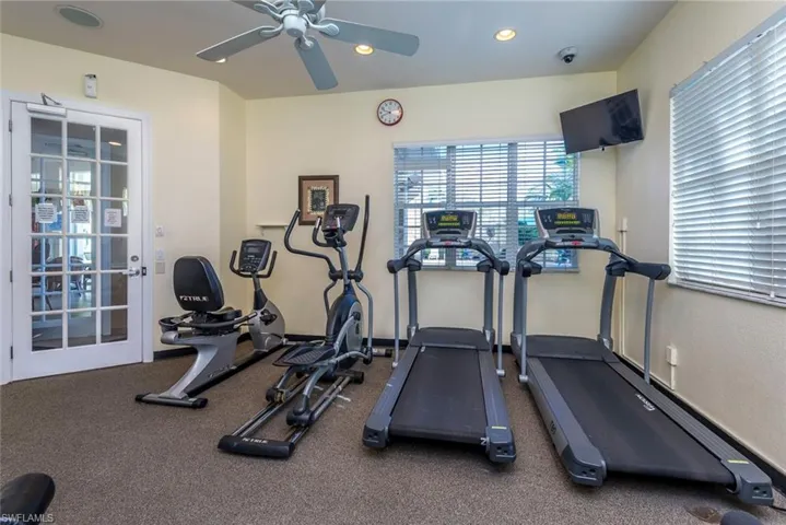 Gym featuring ceiling fan and recessed lighting