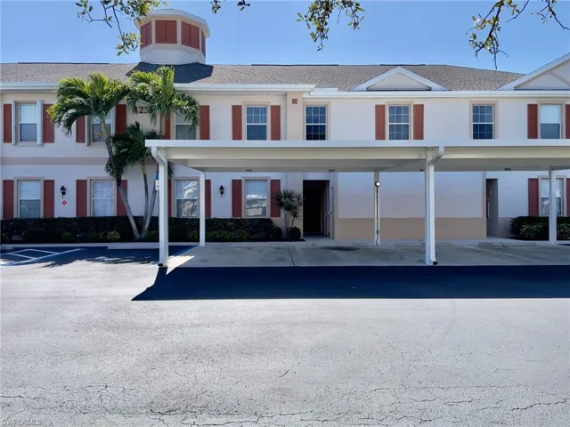 View of property with covered parking