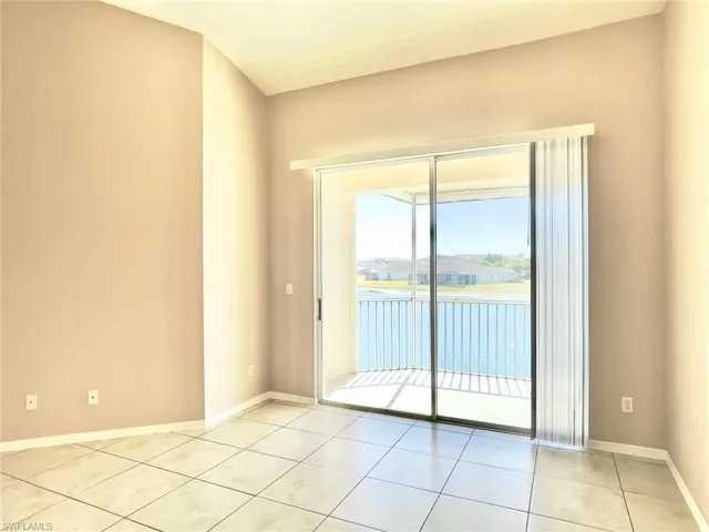 Unfurnished room featuring a water view and light tile patterned floors