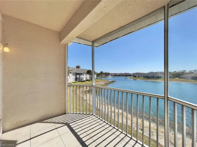 Balcony with a sunroom, a water view, and a residential view