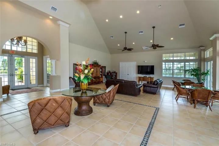 Dining space with recessed lighting, french doors, light tile patterned floors, arched walkways, and ceiling fan