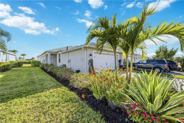 View of property exterior with stucco siding, an attached garage, and a lawn