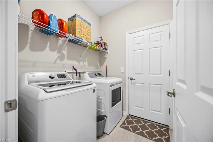 Laundry room with washer and clothes dryer