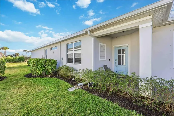 View of home's exterior with stucco siding and a lawn
