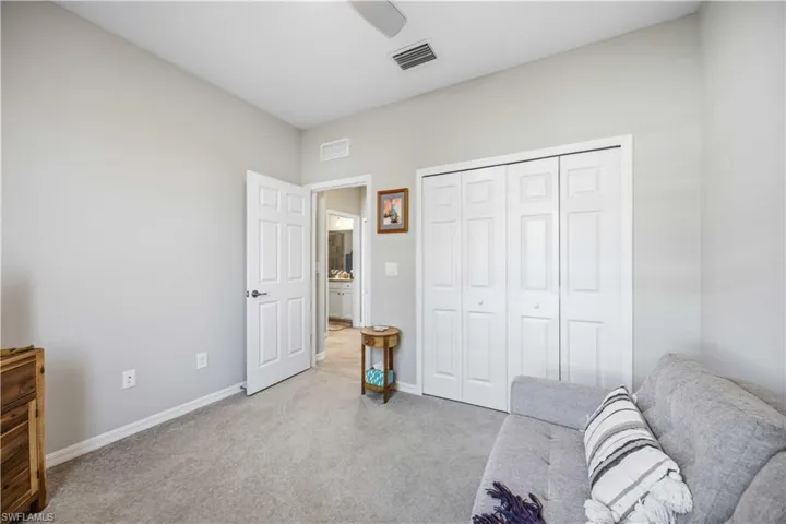 Living area featuring carpet floors and baseboards