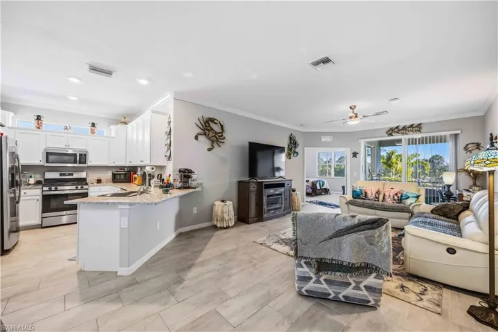 Living area with ornamental molding and ceiling fan