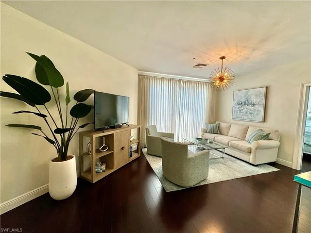 Living room with hardwood / wood-style flooring