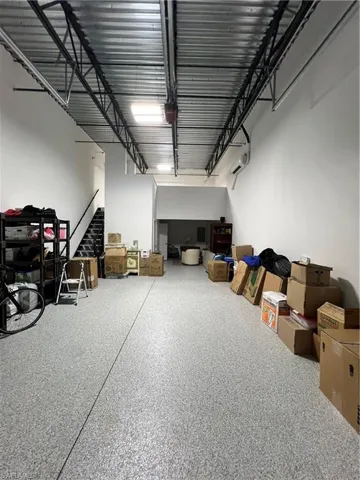 Garage with completed mezzanine, a wall unit AC, 12 x 12 door