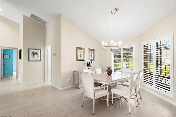 Vaulted ceilings, wood-finish flooring, and white plantation shutters