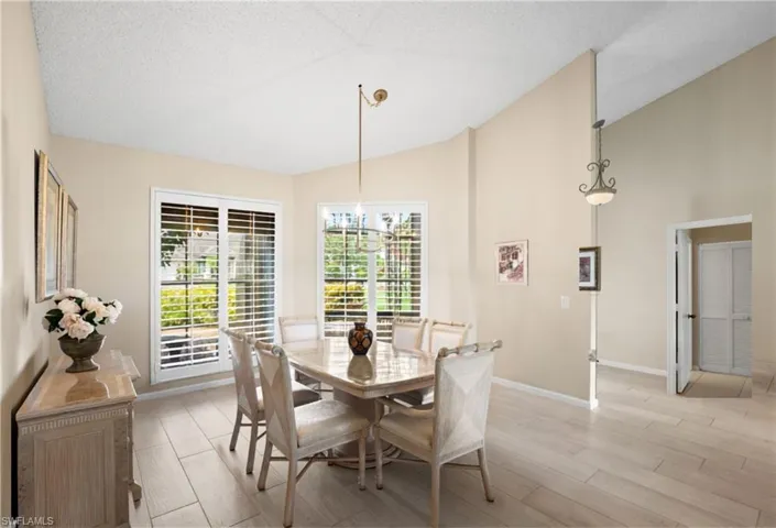 Vaulted ceilings, wood-finish flooring, and white plantation shutters
