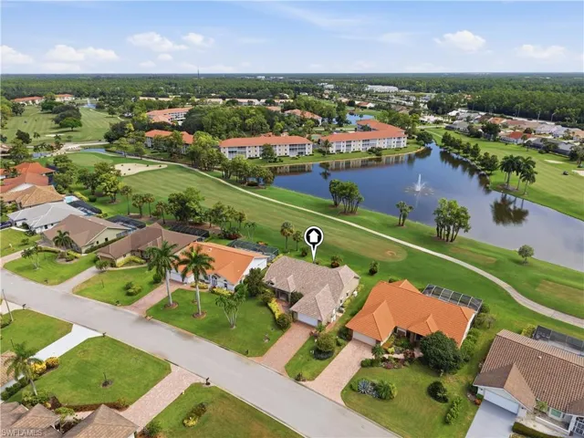 Property bordering a golf course and water feature with fountain