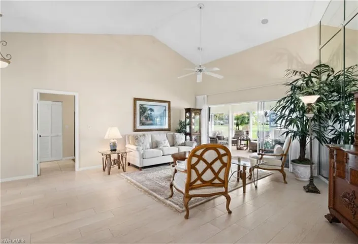 Vaulted ceilings with a ceiling fan, recessed lighting, tile flooring, and large sliding glass doors