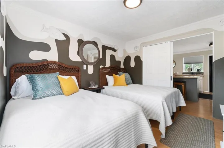 Bedroom with hardwood / wood-style flooring and ornamental molding