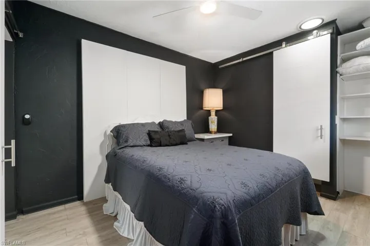 Bedroom with ceiling fan and light wood-type flooring