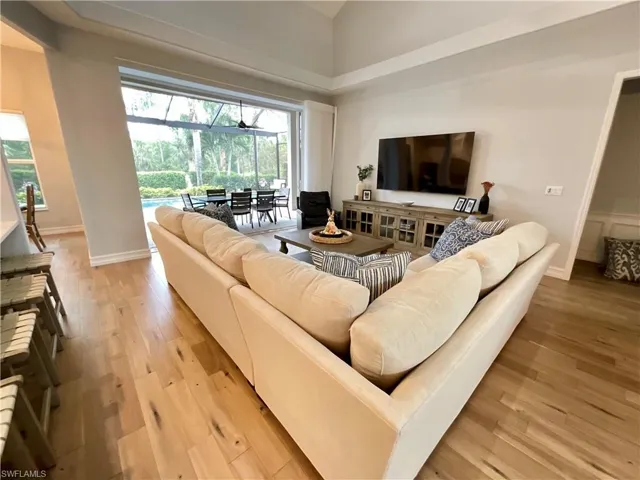 Living room with a wealth of natural light and panoramic pool and preserve views