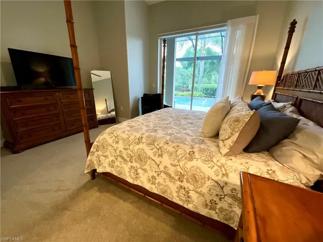 Master bedroom with pool and water view from bed