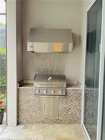 Outdoor kitchen featuring Bull Brand grill & hood