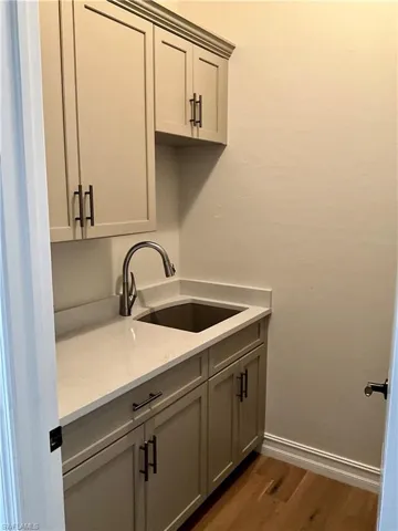 Remodeled laundry with sink and built in cabinets
