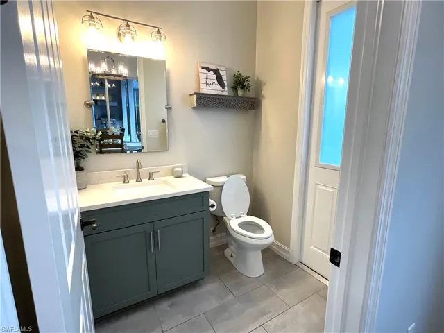 Remodeled Pool Bathroom with patterned flooring and upgraded vanity