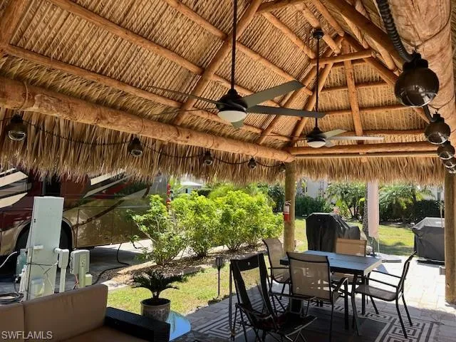 View of patio featuring a gazebo, outdoor dining space, grilling area, and ceiling fan