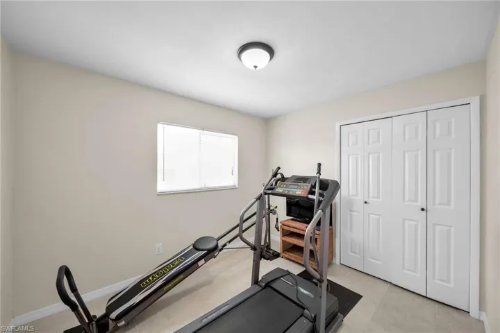 Workout area featuring light tile patterned floors
