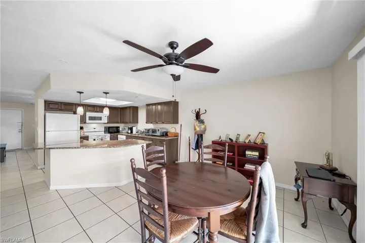 Dining room featuring light tile patterned flooring and ceiling fan