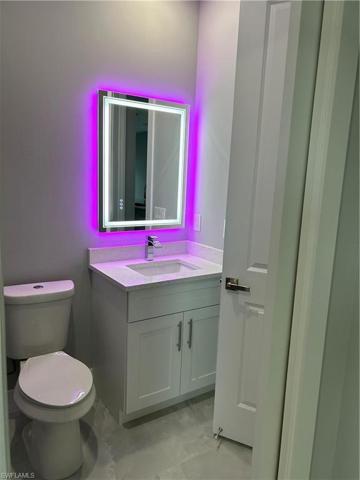 En suite bathroom with RGB lights and connecting door to main living area