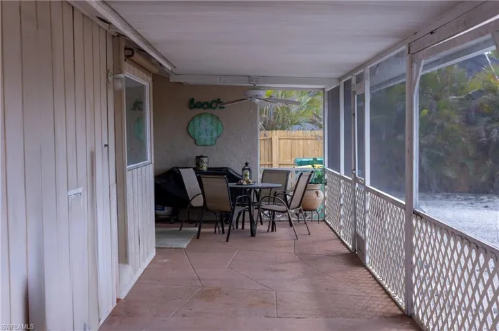 Sunroom with outdoor dining space and ceiling fan