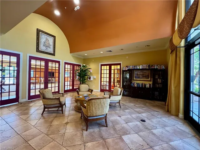 Sitting room with baseboards, high vaulted ceiling, recessed lighting, french doors, and crown molding