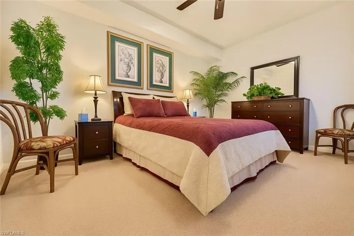 Bedroom with light carpet and a ceiling fan