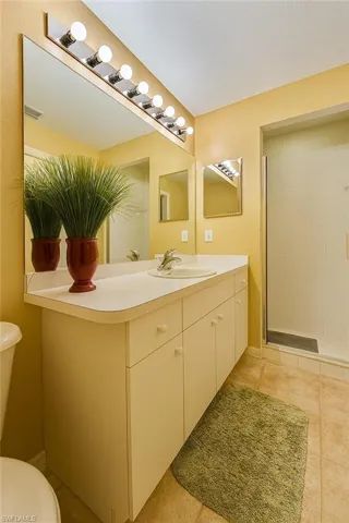 Bathroom featuring vanity, a shower stall, and tile patterned floors