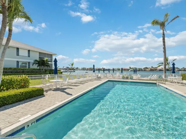 View of pool with a patio and a water view