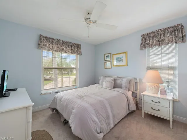 Carpeted bedroom with ceiling fan