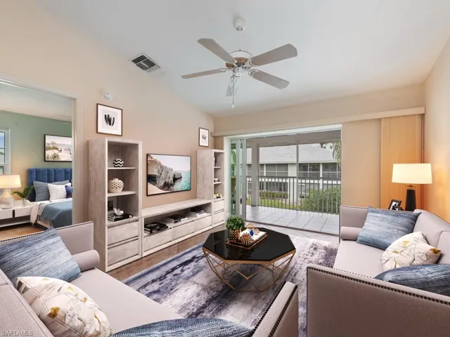 Living room featuring hardwood / wood-style flooring, lofted ceiling, and a wealth of natural light