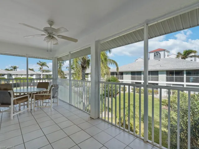 Sunroom / solarium featuring ceiling fan