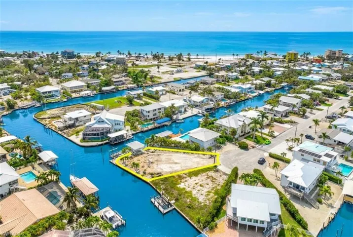 Waterfront parcel with direct canal access, surrounded by residential properties and established infrastructure - Virtually Edited Image