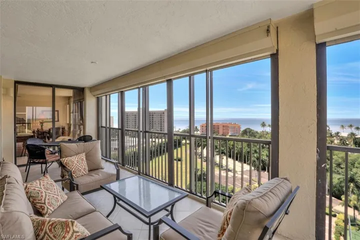 Sunroom featuring a water view