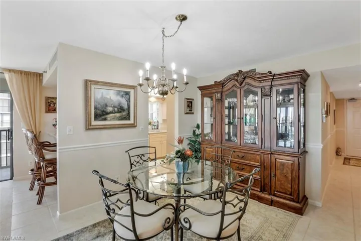 Dining room featuring an inviting chandelier, plenty of natural light, and light tile patterned floors