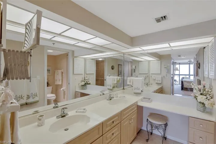 Bathroom featuring vanity, toilet, and tile patterned flooring